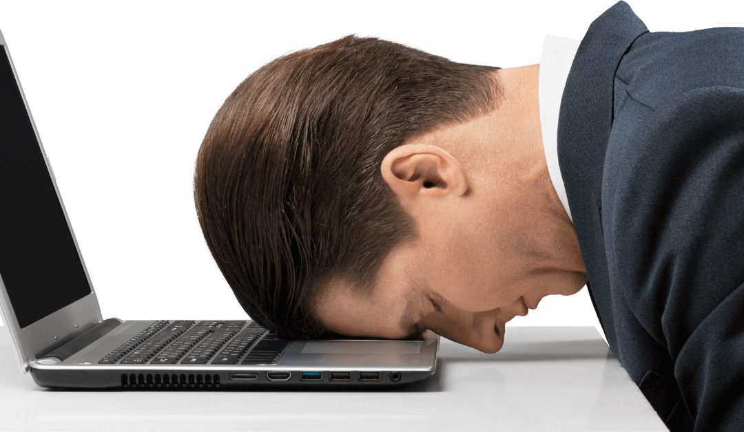 A man putting his head on the laptop thinking "Must I have a career – must I make a difference?".